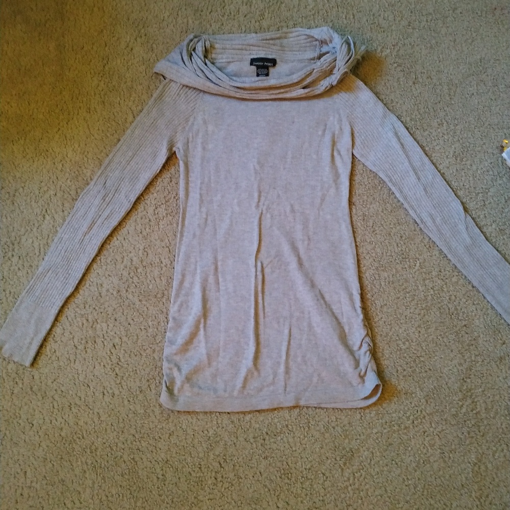 Grey turtle neck sweater .